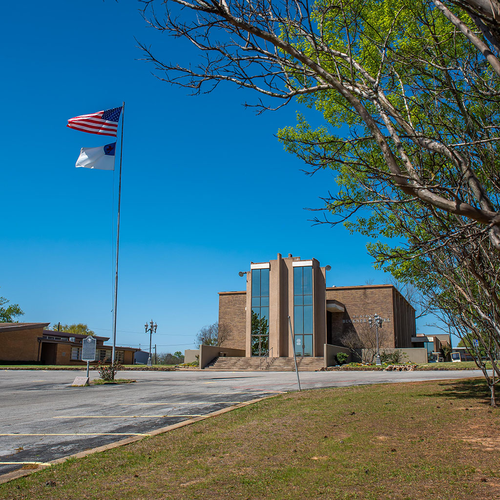 Jacksonville College entrance with flags